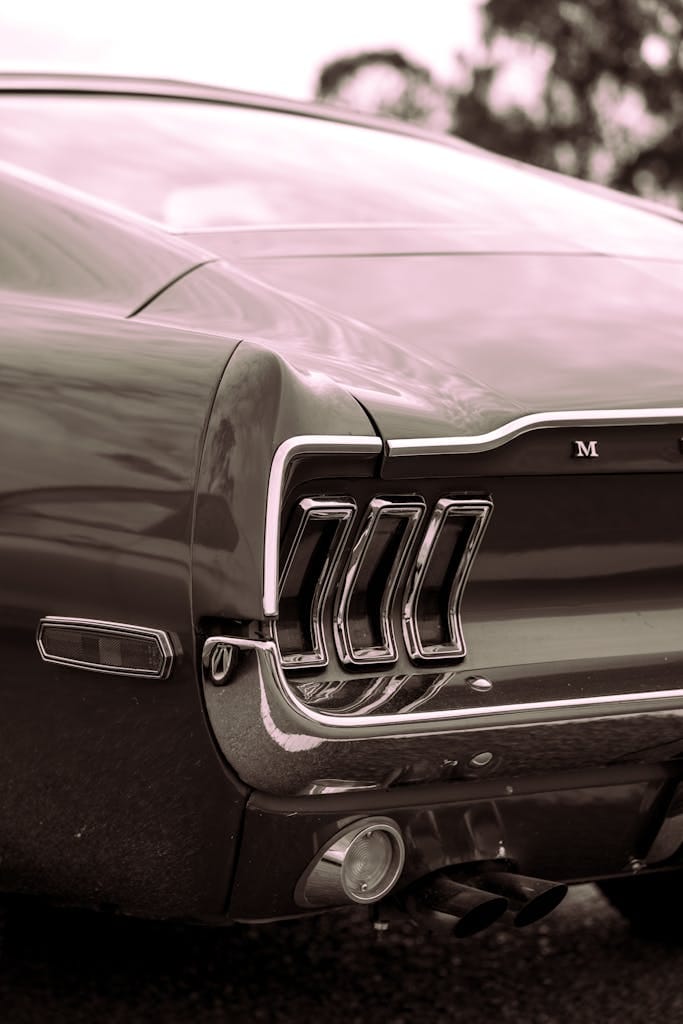 Close-up shot of a sleek vintage Ford Mustang with chrome detailing.